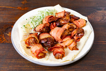 Delicious bacon-wrapped chicken served with fresh vegetables