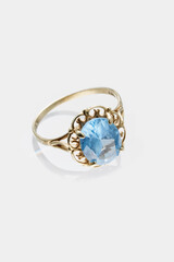 Elegant Gold Ring With Blue Gemstone in Ornate Filigree Setting..