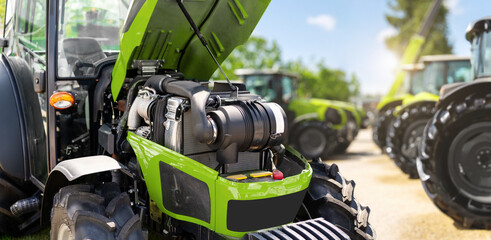 Agricultural machinery industry. Inspection of a modern tractor engine at a dealership © Igor Barilo