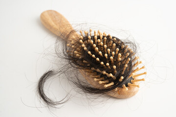 Hair loss fall with comb brush isolated on white background.