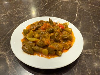 Okra stew topped with chunk of beef and served with white rice, fresh pita bread and lemon.