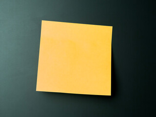 Simple yellow sticky note placed on a gray surface