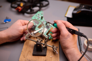Hands Carefully Repairing a Circuit Board with a Soldering Tool for Electronics Projects