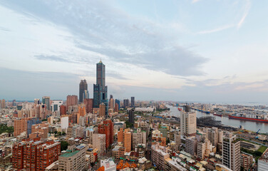 Fototapeta premium Aerial skyline of Kaohsiung Downtown, the vibrant populous seaport city in south Taiwan, with the landmark 85 Sky Tower standing out among high rise buildings in background on a beautiful sunny day