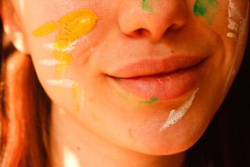 the girl's painted face is smiling