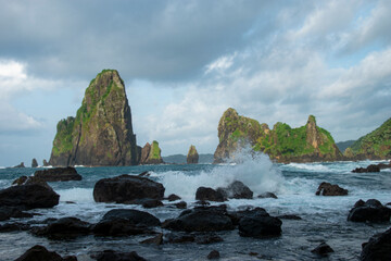 Naklejka premium Beautiful rocky beach with some islets in the background, located in Blitar, East Java, Indonesia.