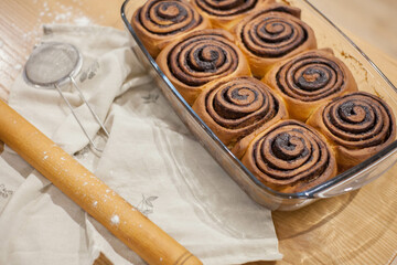 Fresh homemade cinnamon rolls or scones with white cream sauce. banner, menu, place for text recipes, top view