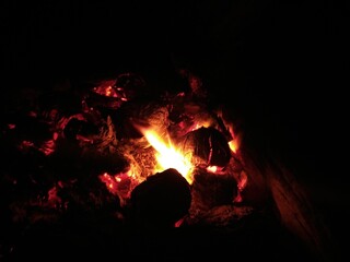 Fototapeta premium Warm Bonfire from Coconut Shells by the Sea at Night