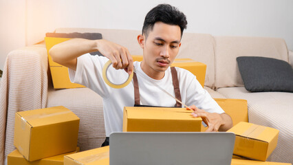Small business owner packing boxes for online orders ready for shipping, Man taping cardboard boxes for shipping, Preparing to send packages, preparing/packing boxes of online orders