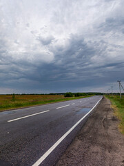 Road with a cloudy sky in the background
