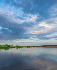Fototapeta premium Calm lake with a cloudy sky in the background