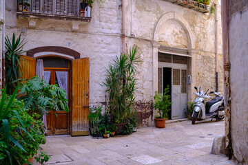 A motorcycle is parked in front of a large, impressive building