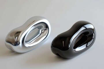 Sleek fluid forms in metallic silver and black, modern and tech-inspired, with smooth curves and organic bean shapes for a futuristic aesthetic.