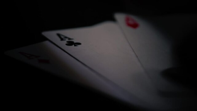 Poker player holding aces playing cards 