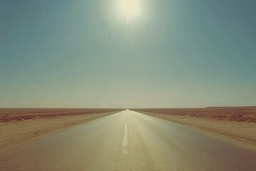 Naklejka premium A road through a field with the sun shining on the horizon