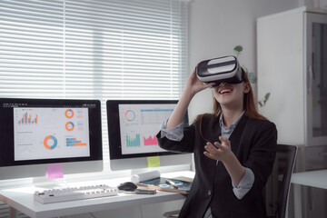 Businesswoman using vr headset is analyzing financial data displayed on computer screens in modern office, exploring immersive data visualization and futuristic business technology