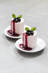 Italian dessert. Black Currant Cream pudding cylindrical shape. Panna Cotta. With Black Currant sauce. Close up