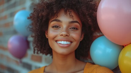 Fototapeta premium carefree woman posing with bright helium balloons in front of a textured brick wall creating a modern and happy scene