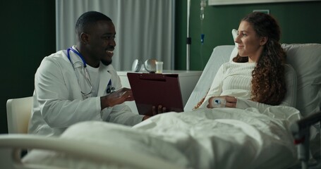Empathetic doctor sits with a young patient, ensuring she understands her treatment.