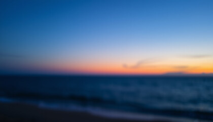 A blurred seascape at twilight with deep blue tones, creating a serene and peaceful abstract ocean view.