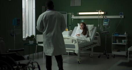 Doctor enters the room with a tablet, ready to review the patient's progress.