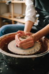 Process of making a unique ceramic shape. Potter creates a ceramic bowl in the pottery studio.