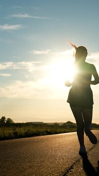 silhouette sports girl running along road sunset, loves run outdoors, challenging yourself, new normal sport, exercise, well-being running, sprint running, profile exercises, against backdrop