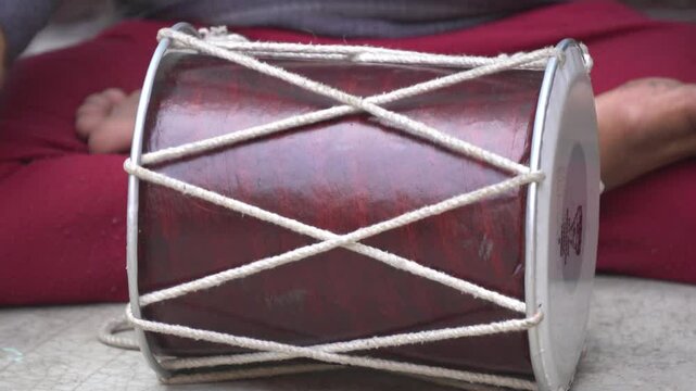 Traditional dholak drum with dual heads, used in folk music and celebrations, delivers rich rhythmic beats for festive and cultural events