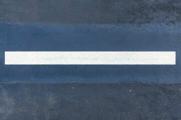 There is a road featuring a white arrow that points directly to the ocean