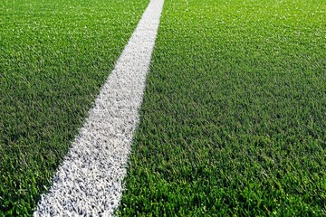 An aerial view of a green football field with white markings