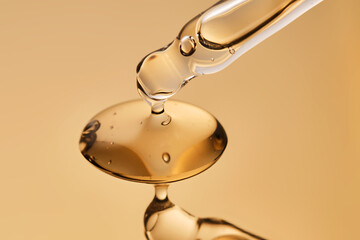 A pipette with a beautiful drop of gel-textured facial serum.