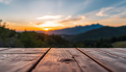 A wooden deck overlooking a stunning sunset over distant mountains, creating a peaceful and warm evening atmosphere with golden light and scenic views.