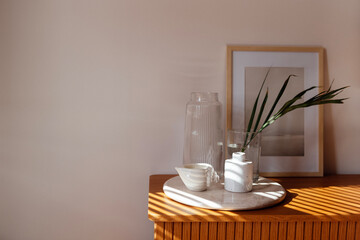 Close-up of the aesthetic details of the home interior. Ceramic tray on a wooden chest of drawers
