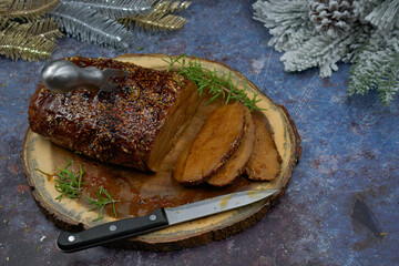 Roasted seitan rubbed with spices and bbq sauce on wooden board, sliced, copy space