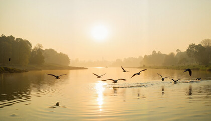 Naklejka premium Flock of birds soaring above tranquil river at sunset, harmony in nature