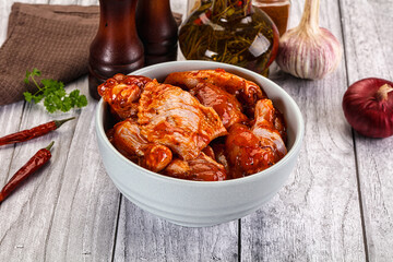 Raw marinated buffalo chicken wings
