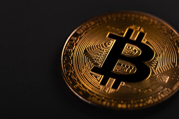 Bitcoin gold coin on the dark black background. Digital cryptocurrency virtual money. Blockchain technology. P2P bitcoin trading. Peer-to-peer payment system