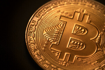 Bitcoin gold coin on the dark black background. P2P bitcoin trading. Peer-to-peer payment system. Blockchain technology. Digital cryptocurrency virtual money.