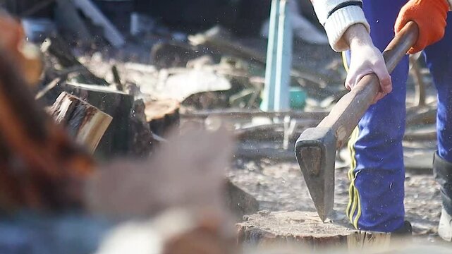 close-up of an axe cutting a log, slow motion