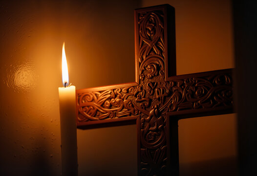 Intricate carved cross illuminated by candlelight, reverent symbolism