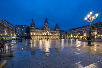 Night view of Plaza María Pita in A Coruña, Galicia, with its illuminated architecture reflected...