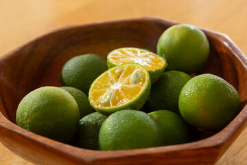 A closeup view of a bowl of calamansi.