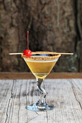 Glass with alcoholic drink with lime and ice (Gin & Tonic) isolated on old wood scene 