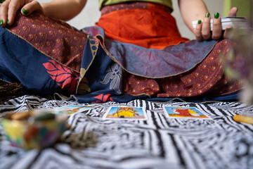 Mystical Tarot Reading: A person delves into the world of divination, consulting tarot cards laid...