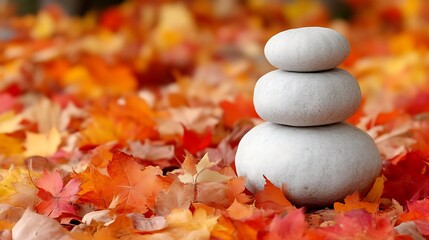 Stacked Stones Resting On Autumn Leaves