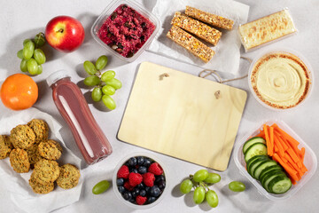 Ready to eat supermarket meal with board for text. Quick food for lunch break, ready vegan meals, flat lay, copy space