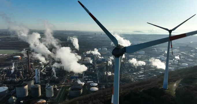 Wind turbines, next to chemical park, industrial zone in the german ruhr area. Aerial drone view.