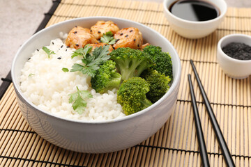 Tasty rice with broccoli and chicken served on table, closeup