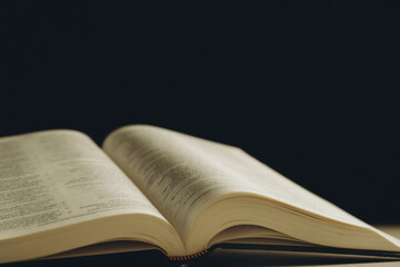 Open Holy Bible on beige table, closeup