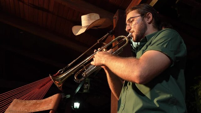 Bottom shot of inspired young man playing the trumpet